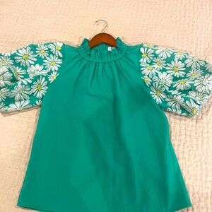 THML green top with white daisies on the pouf sleeves, wooden buttons down back.